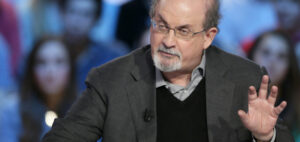 In this file photo taken on November 16, 2012, British author Salman Rushdie takes part in the TV show "Le grand journal" on a set of French TV Canal+ in Paris. - Rushdie, whose controversial writings made him the target of a fatwa that forced him into hiding, was stabbed in the neck by an attacker on stage Friday in western New York state, according to New York State Police. The attacked is in custody. (Photo by Kenzo TRIBOUILLARD / AFP)