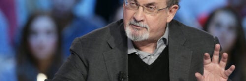 In this file photo taken on November 16, 2012, British author Salman Rushdie takes part in the TV show "Le grand journal" on a set of French TV Canal+ in Paris. - Rushdie, whose controversial writings made him the target of a fatwa that forced him into hiding, was stabbed in the neck by an attacker on stage Friday in western New York state, according to New York State Police. The attacked is in custody. (Photo by Kenzo TRIBOUILLARD / AFP)