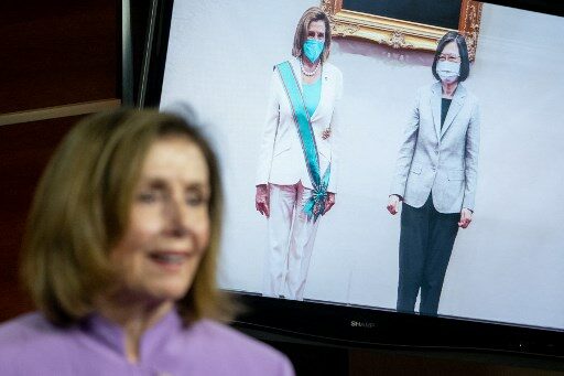 An image of US Speaker of the House Nancy Pelosi (D-CA) meeting with Taiwan's President Tsai Ing-wen during her stop in Taiwan is displayed as Speaker Pelosi speaks during a press conference on Capitol Hill in Washington, DC, on August 10, 2022. (Photo by SAUL LOEB / AFP)